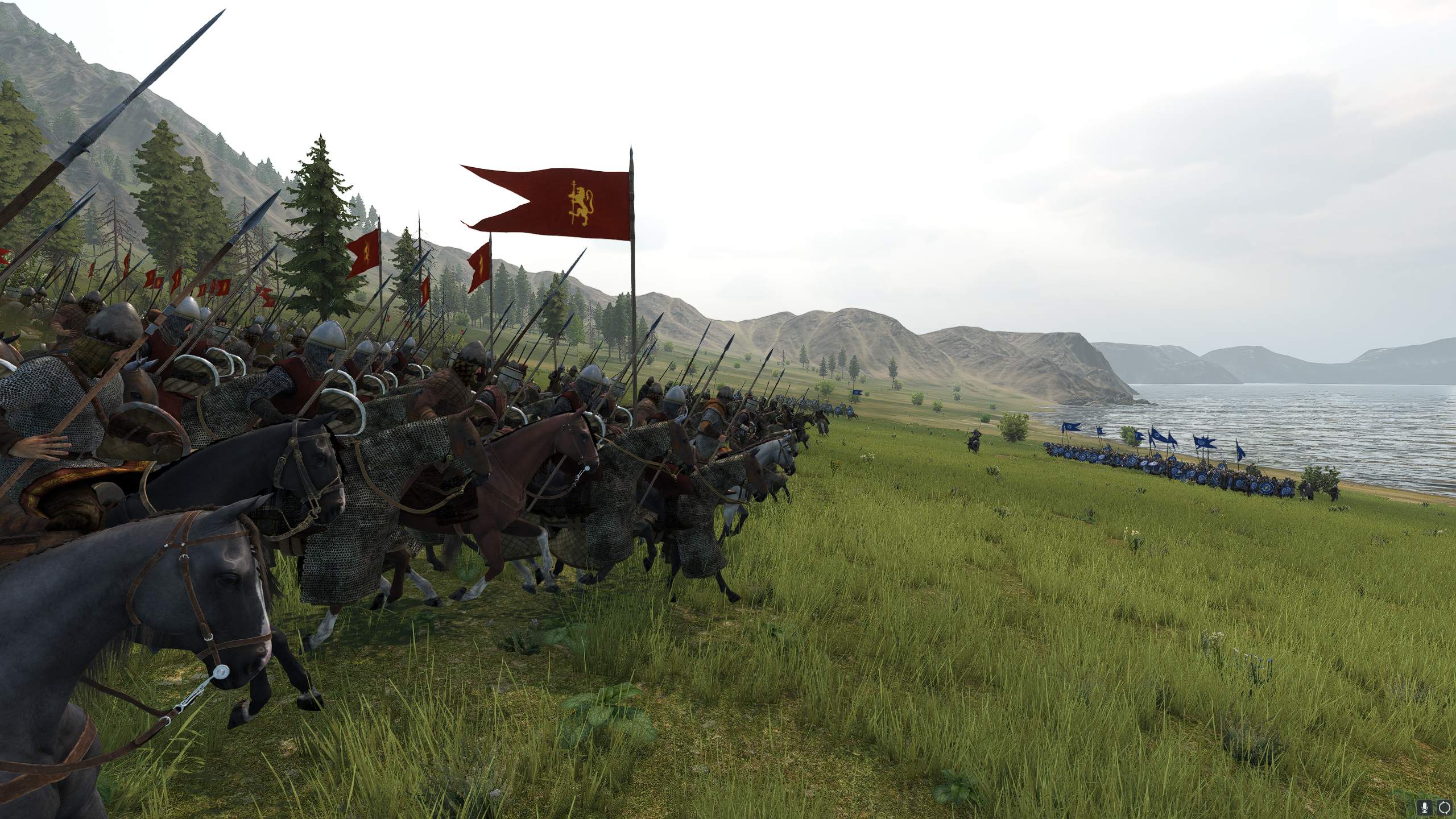 Cavalry carrying red banners charges toward a blue shield wall beside the coast