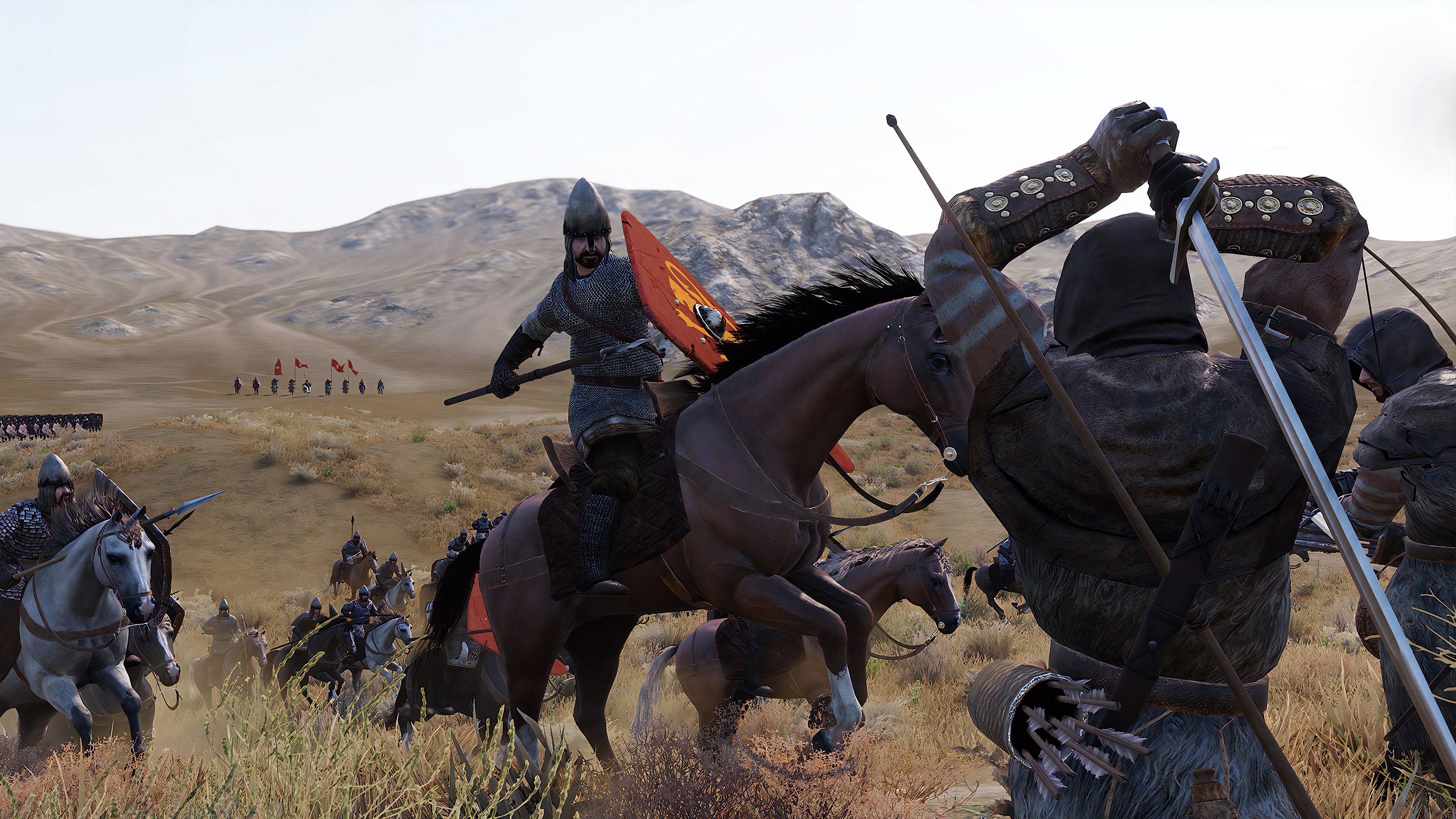 A mounted warrior with a red shield clashes with infantry on a desert battlefield